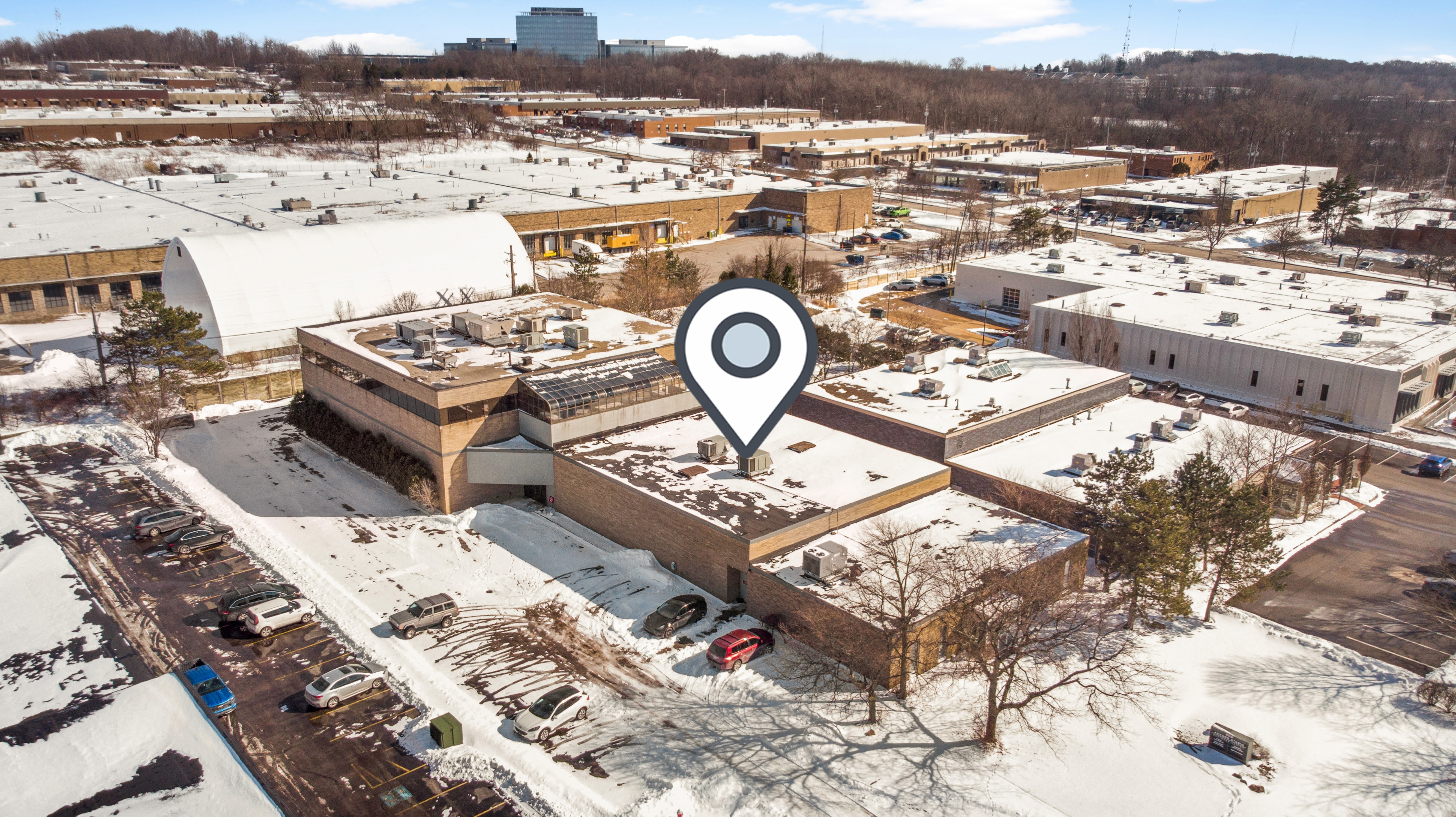 Aerial view of commercial complex with map pin