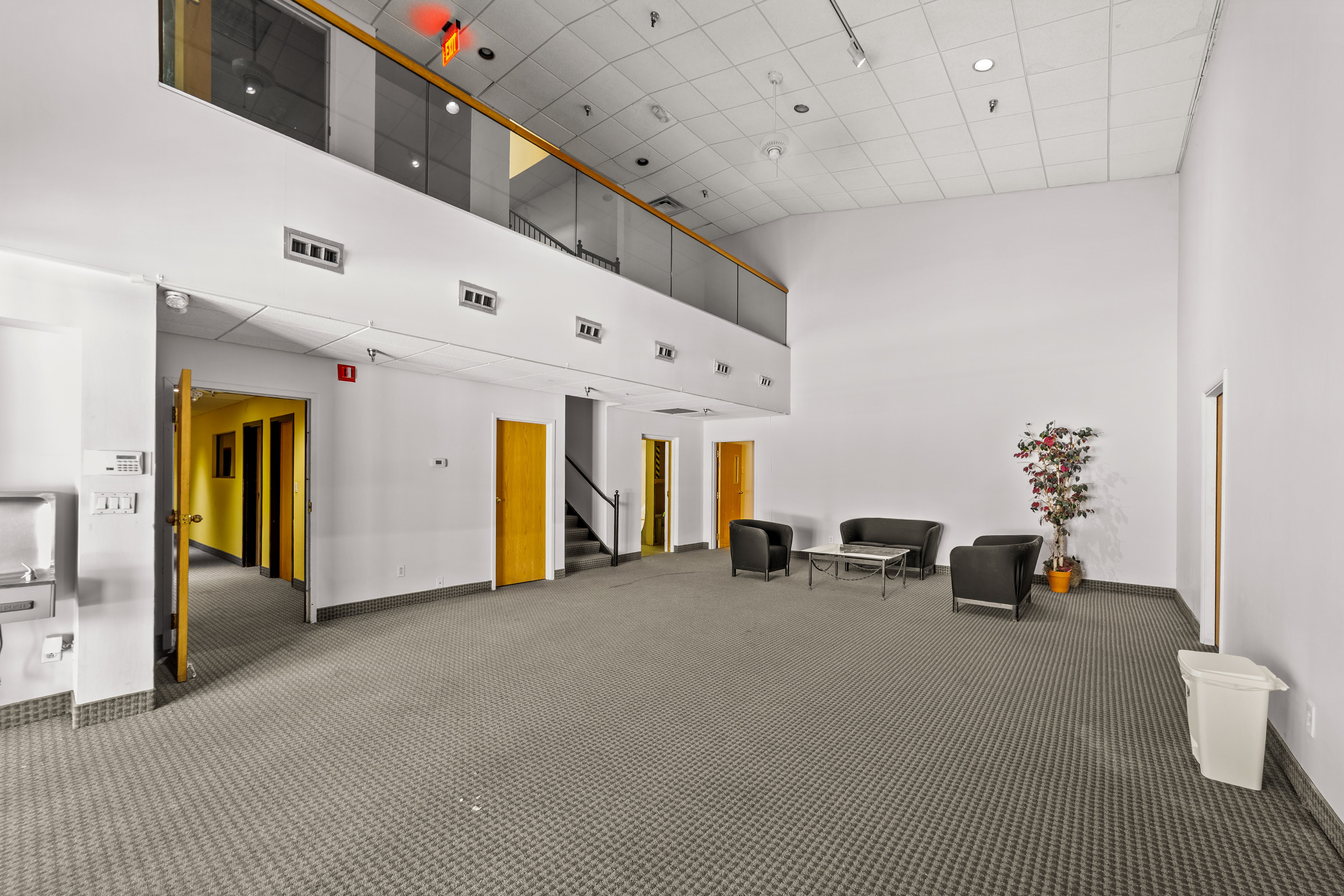 Spacious carpeted lobby with mezzanine