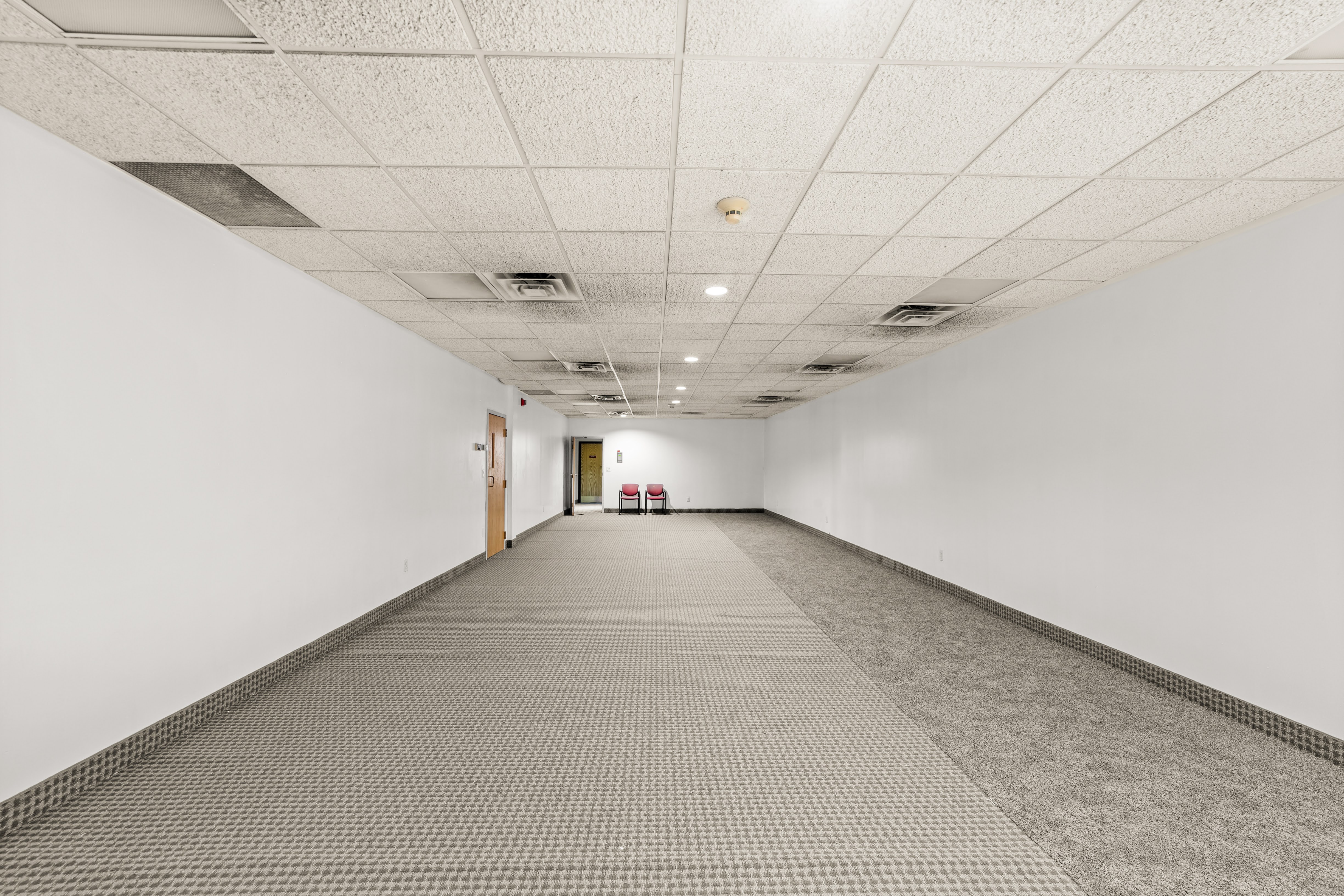 Empty office hallway with two patterns of carpet