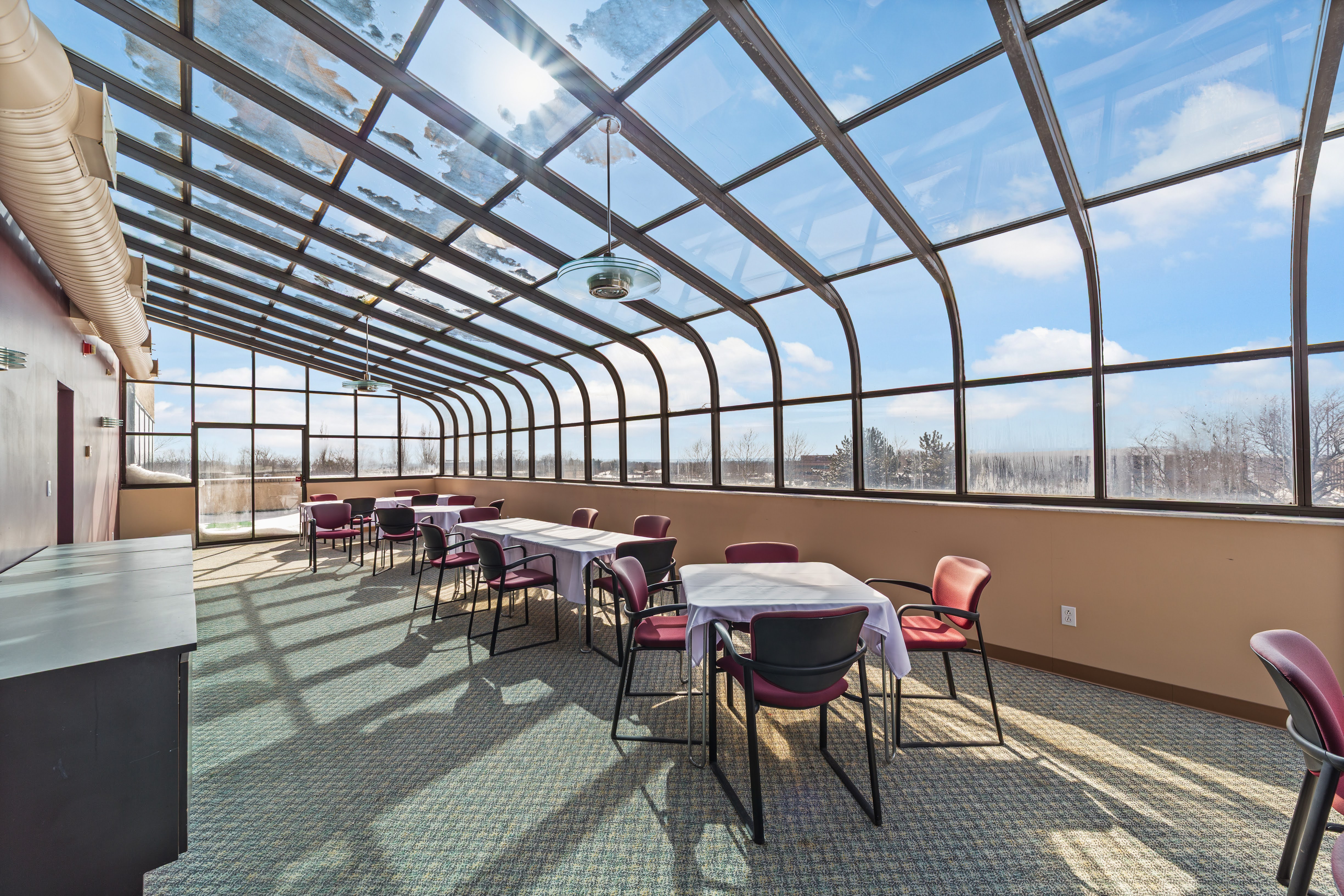 Solarium dining area with curved glass roof