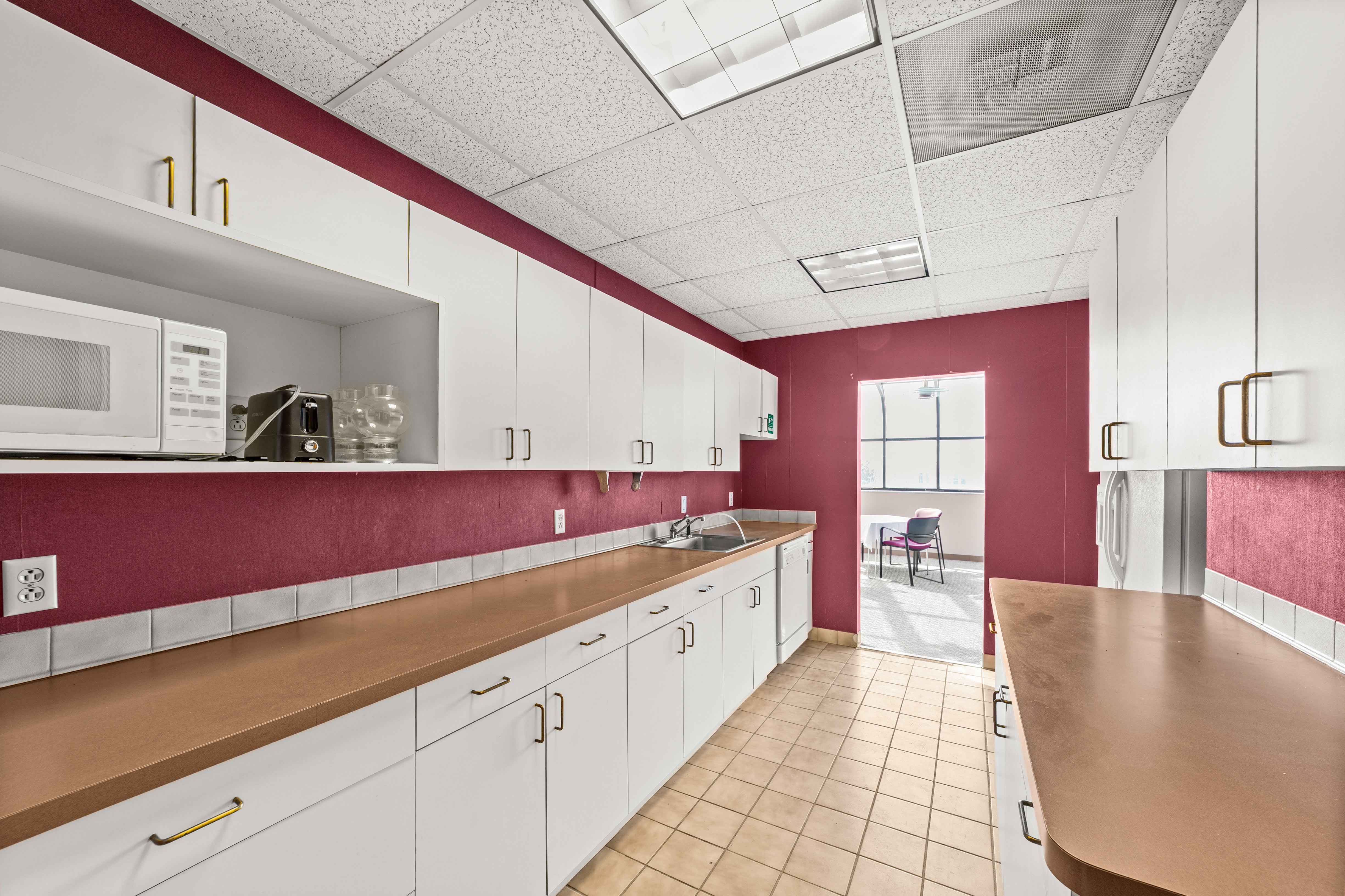 Office kitchenette with red textured walls