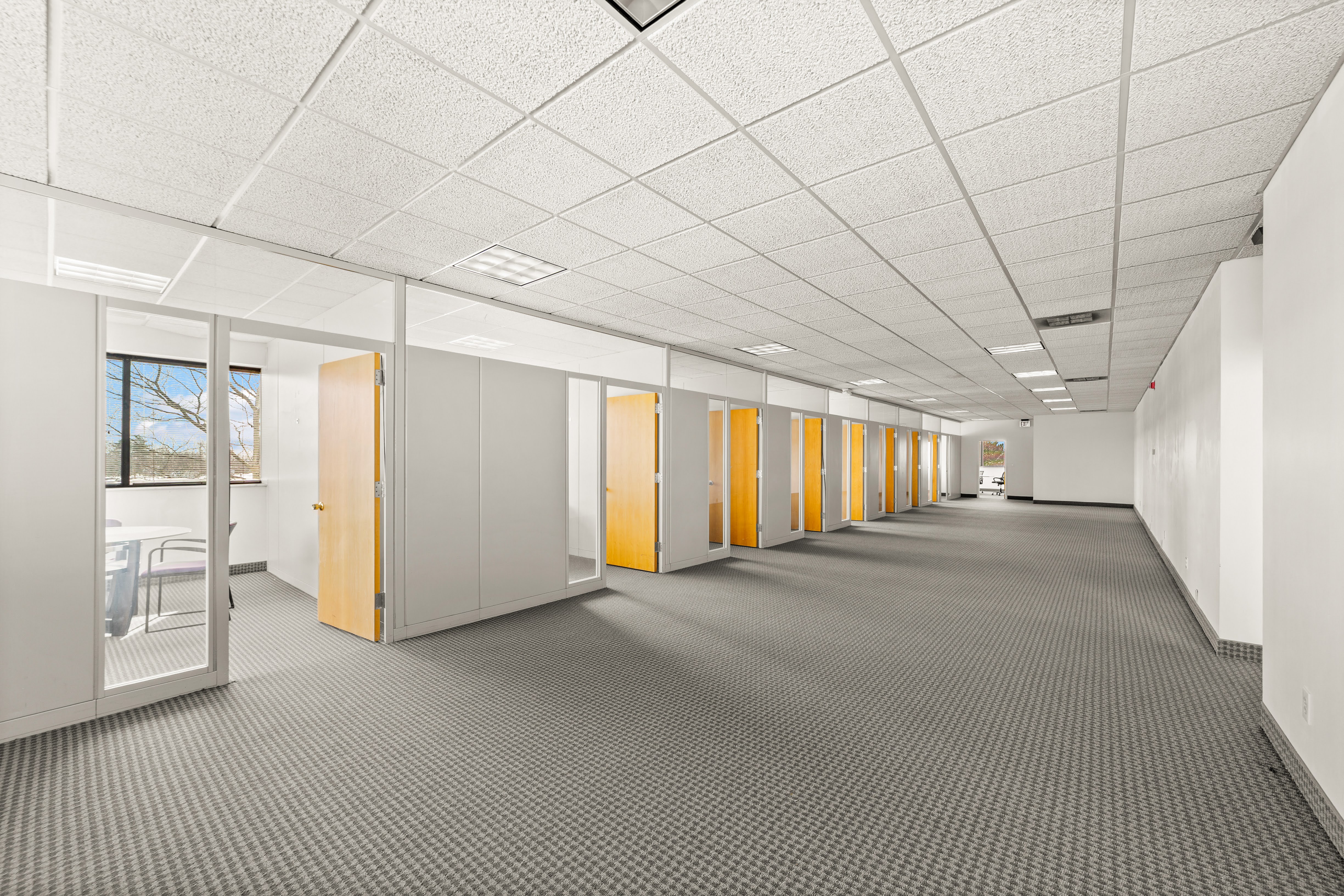 Long empty office corridor with private offices