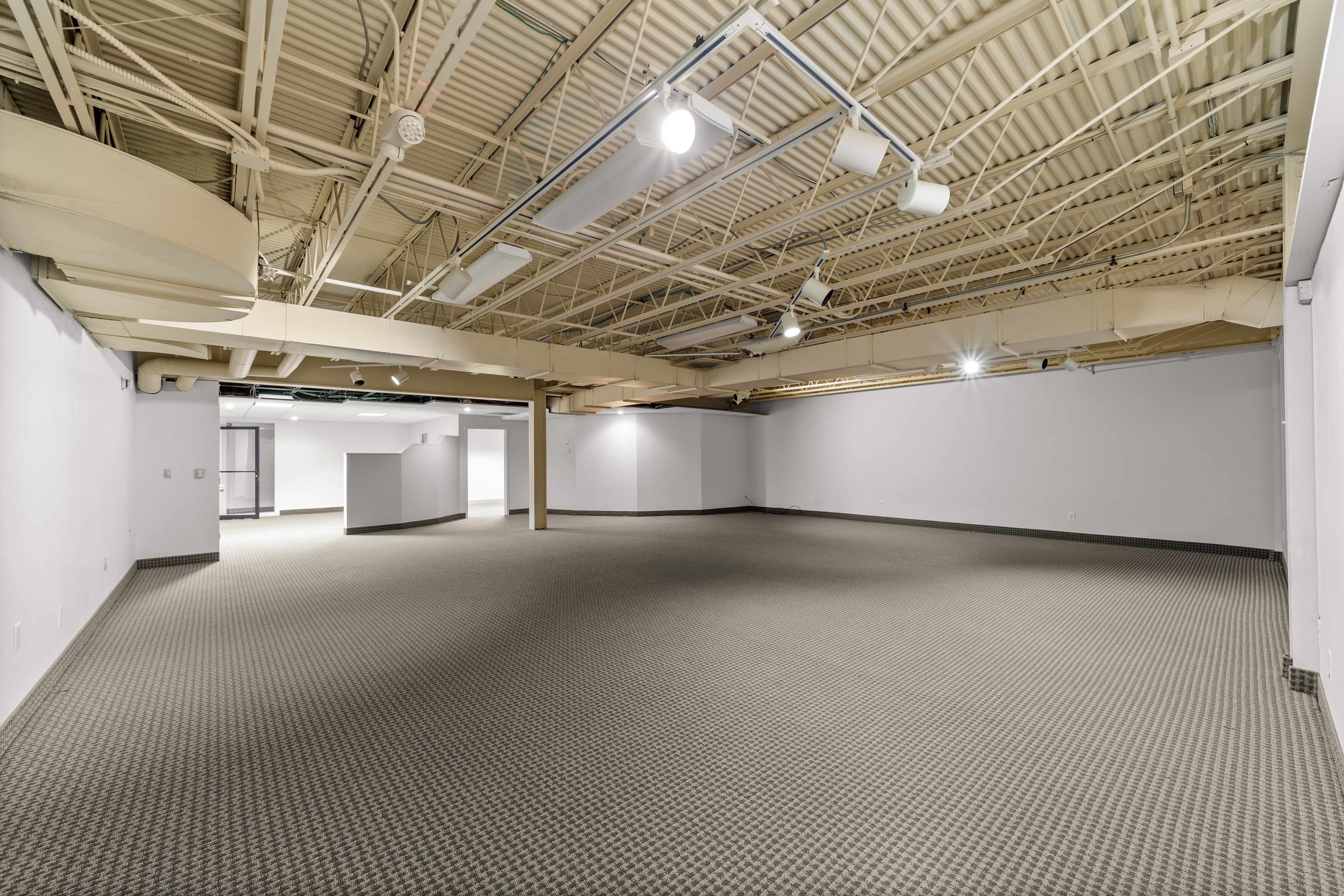 Empty commercial space with exposed industrial ceiling
